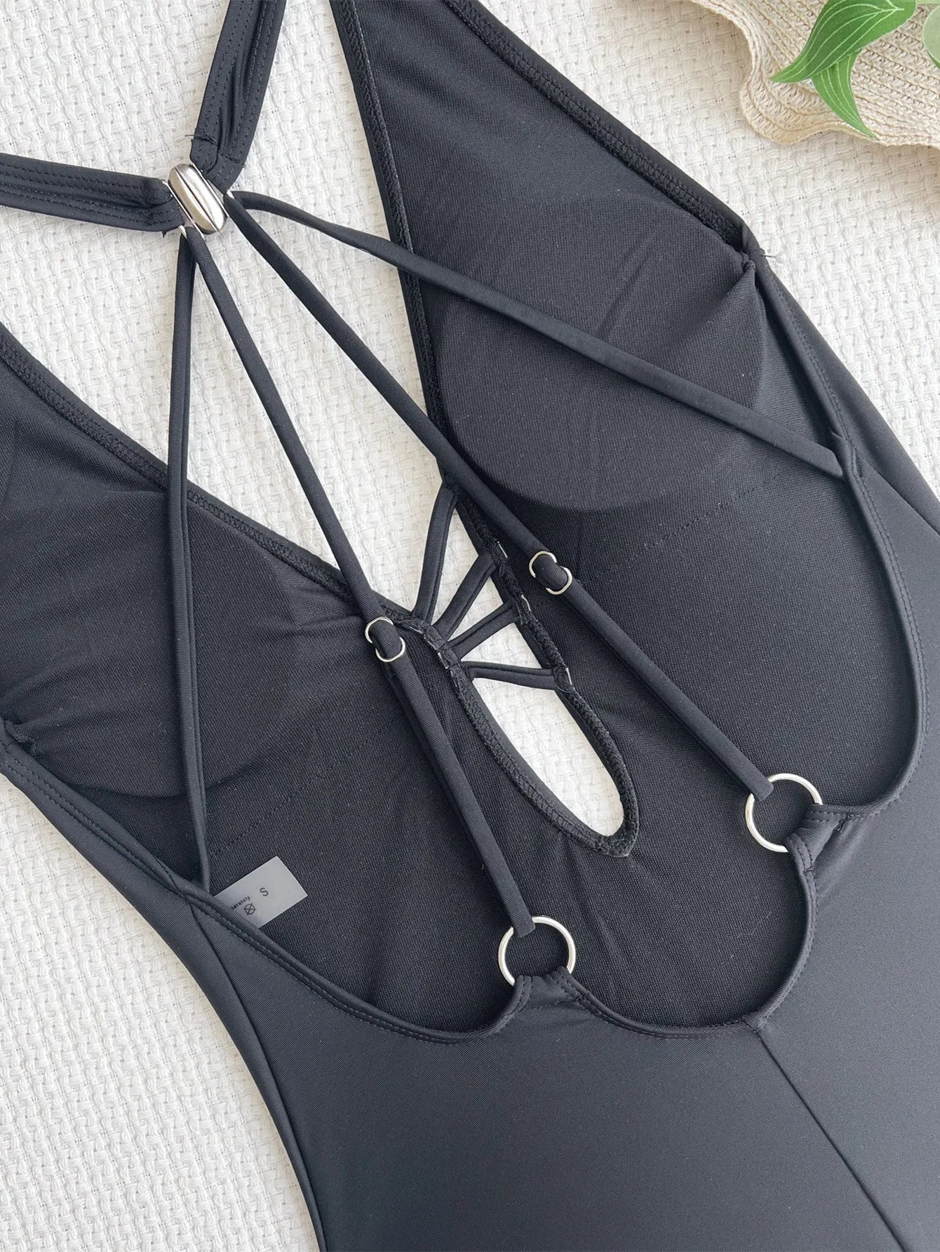 Ladies solid black one-piece nylon bikini for swimming.