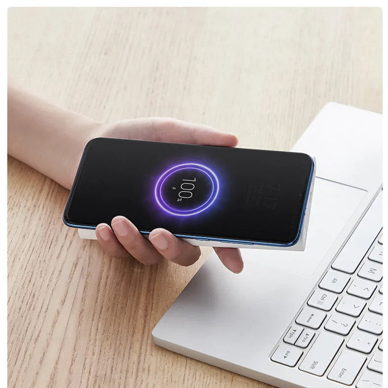 White or black 10000 mAh power bank with fast charging and wireless output for tablets and cameras