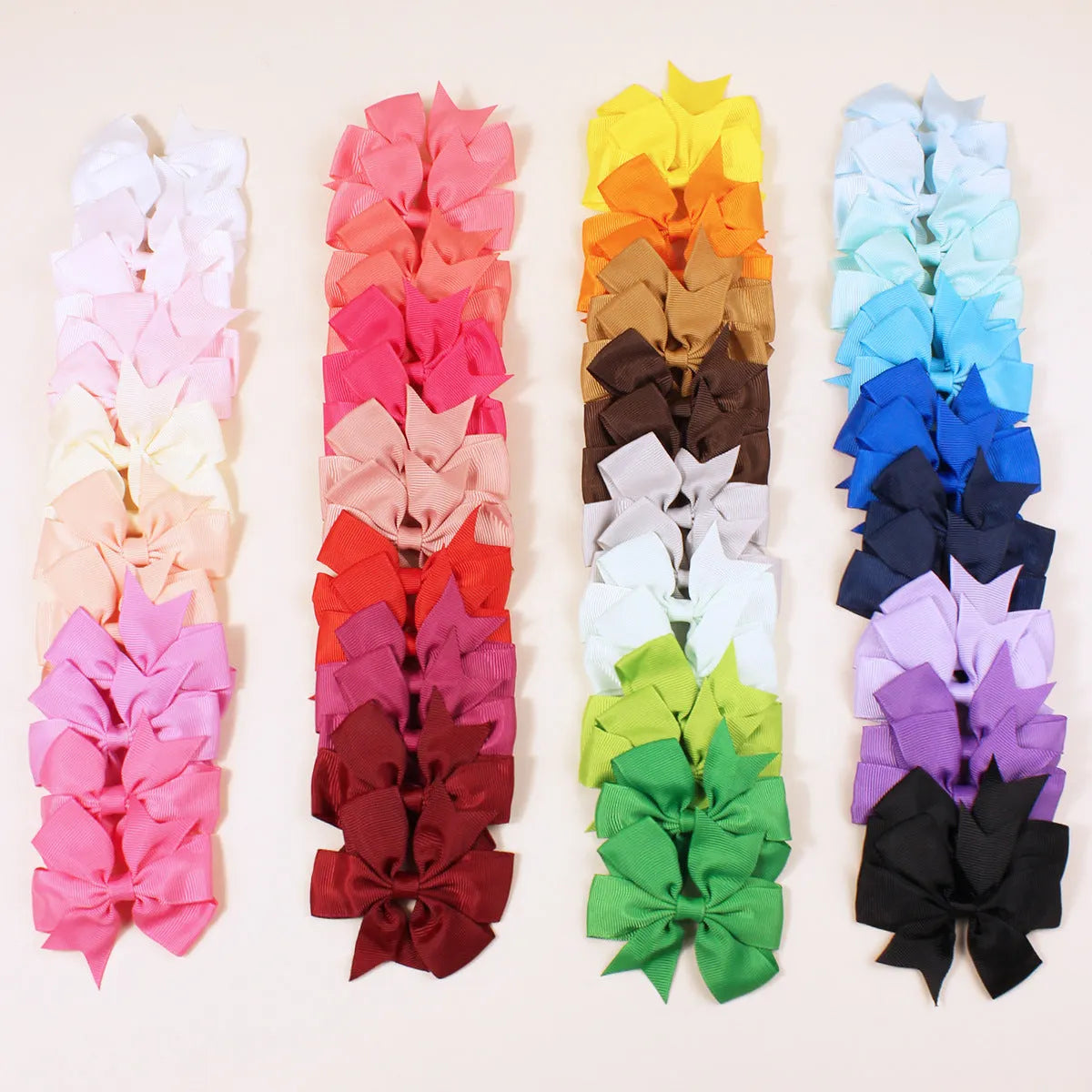 Assorted colourful handmade grosgrain ribbon pinwheel hair bows with alligator clips for toddlers.
