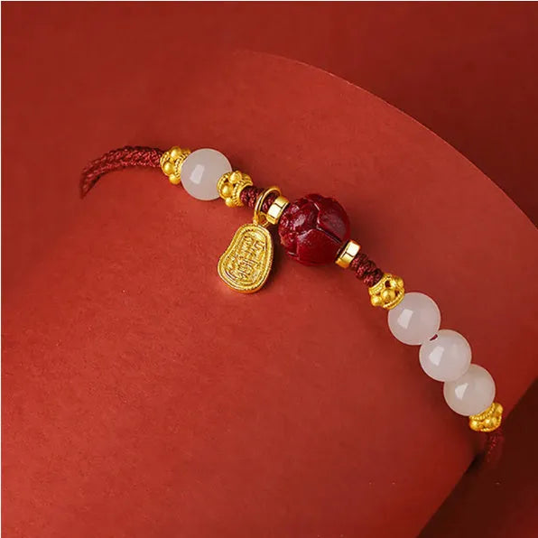Hetian jade and cinnabar red rope women's bracelet with adjustable sterling silver chain.
