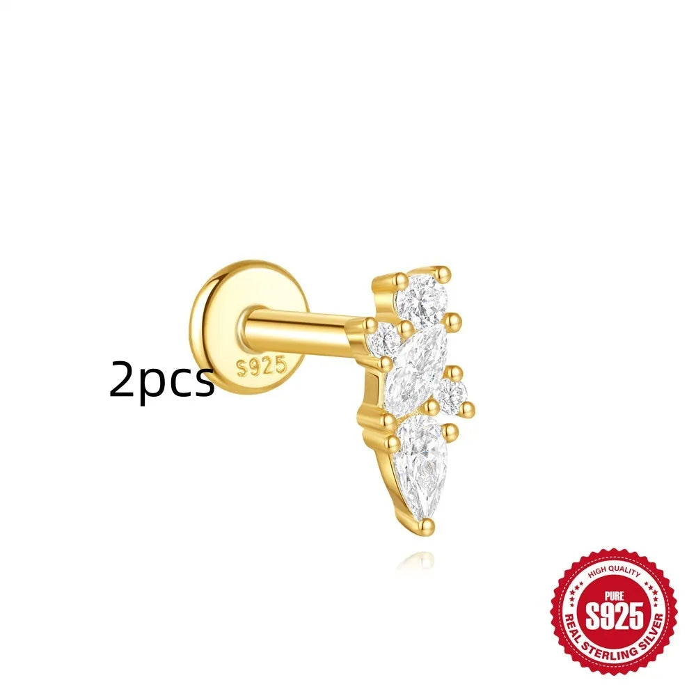 Geometric kite-shaped sterling silver stud earrings with rhinestones and a gold chain tassel.