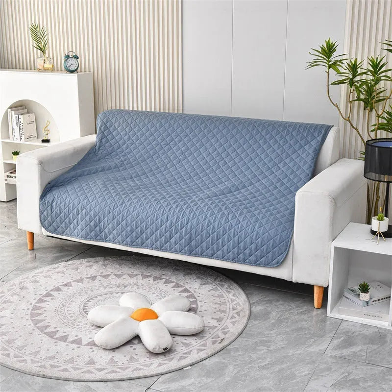 Reversible dog blanket sofa cover in grey and cream colours laid flat on a sofa