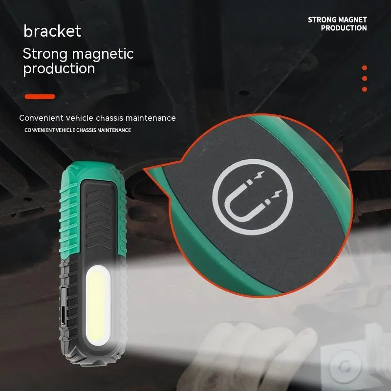 Black and green auto repair work light with USB charging port and clear lens