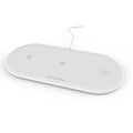 Black three-in-one wireless charging station for iPhone, Apple Watch, and headphones on a desk