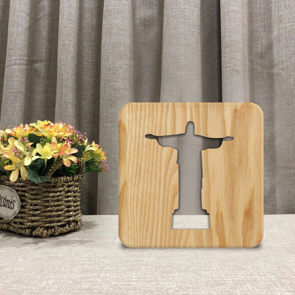 Solid wood hollow night lamp with warm white LED light on a surface.