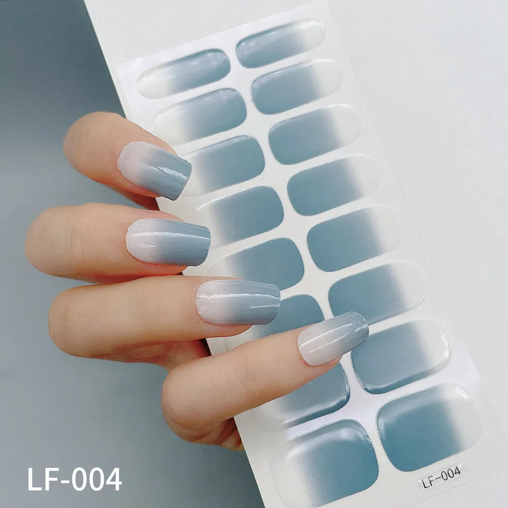 Full sheet of nail art stickers showing sixteen small designs including cross, rose, tulip, and leopard print patterns.