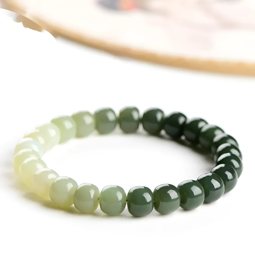 Natural Hetian jade bracelet showing water gradient colour variation on polished surface