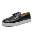 Men's brown artificial PU leather slip-on sneakers with a tassel detail on the round toe.
