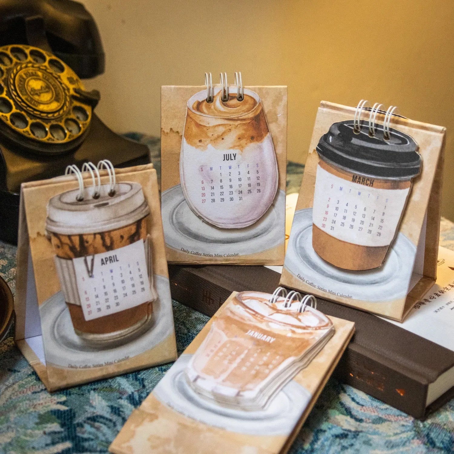 Mini 2025 desk calendar showing four design options including coffee time and motivational phrases