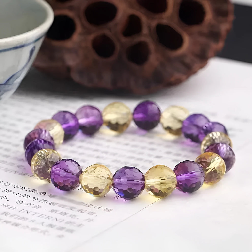 Handmade ametrine bracelet with 128-facet crystal beads in a choice of diameters and symbolic designs.