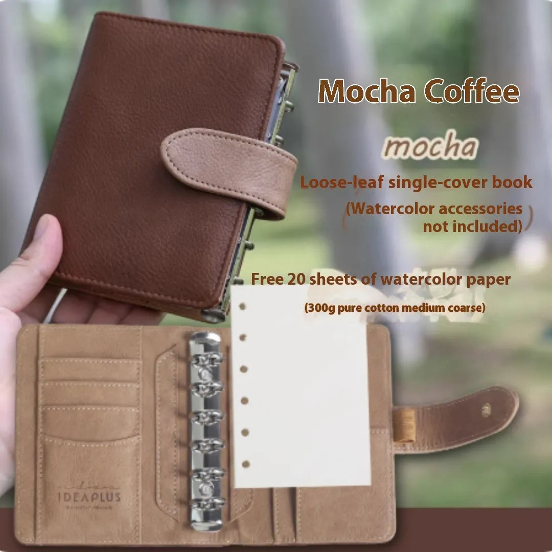 A7 format loose-leaf watercolour notebook in green, open to show removable pages suitable for painting.
