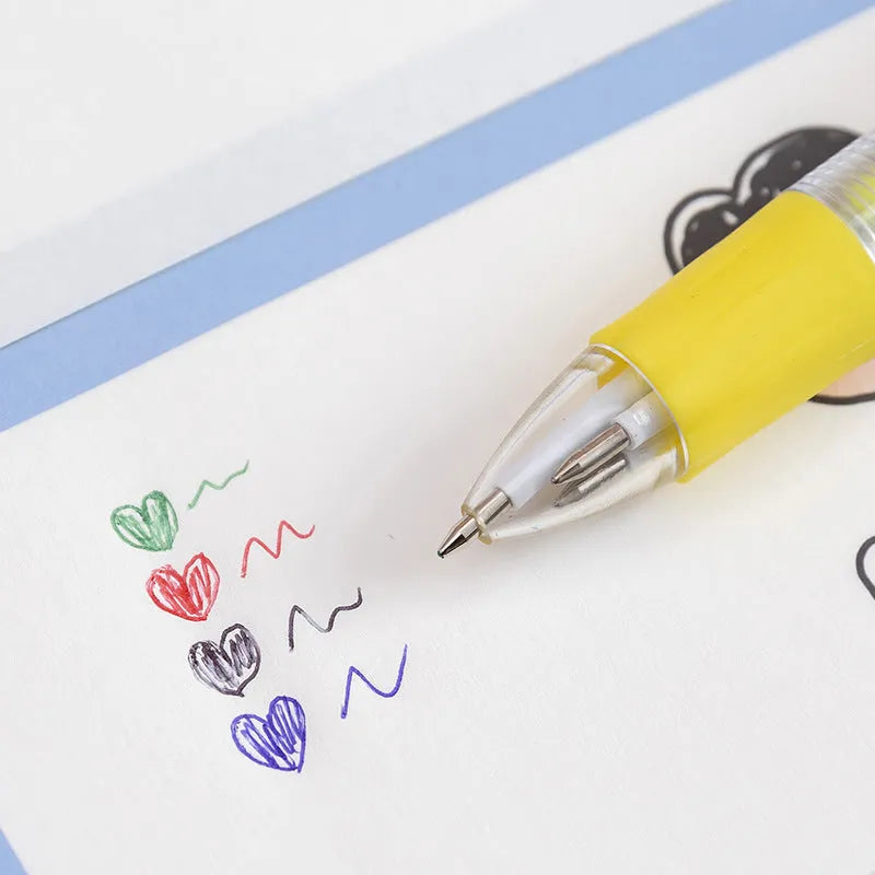 Cute cartoon four-colour press ballpoint pen with silicone grip and 0.7mm tip on a notepad.