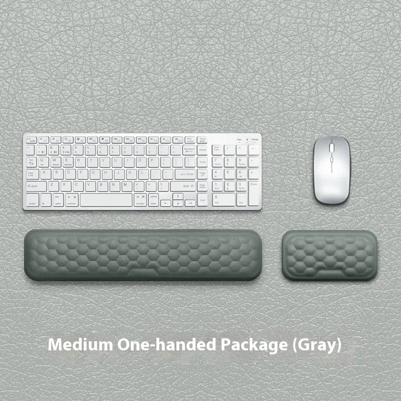 Grey and black memory foam mouse wrist pads with silicone bases, shown in cloth and leather cover options.