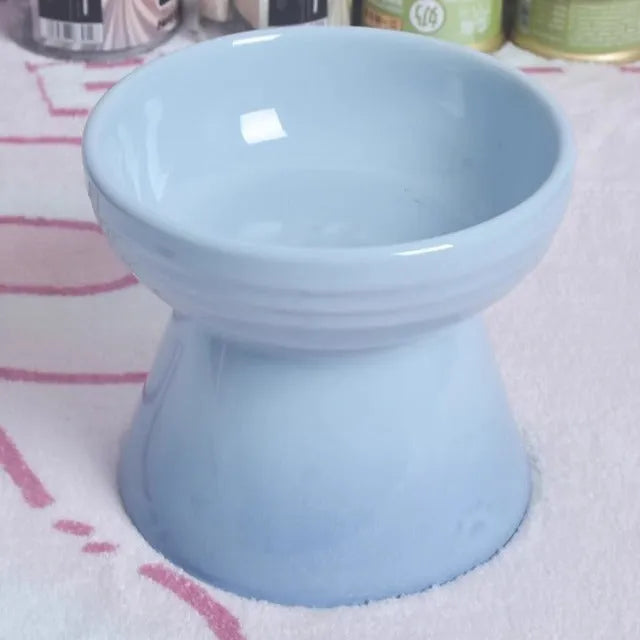 Black chin-high foot ceramic pet bowl for dogs and cats on a flat surface.