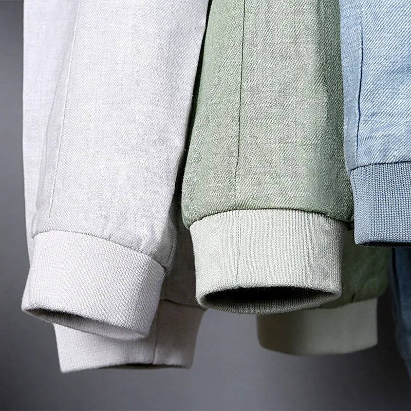 Men's thin blue cotton linen jacket with long sleeves, shown on a hanger.