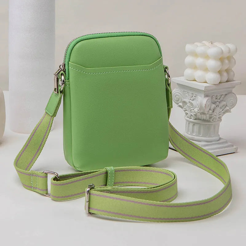 Small solid colour PU leather crossbody bag for women in black, shown with shoulder strap.