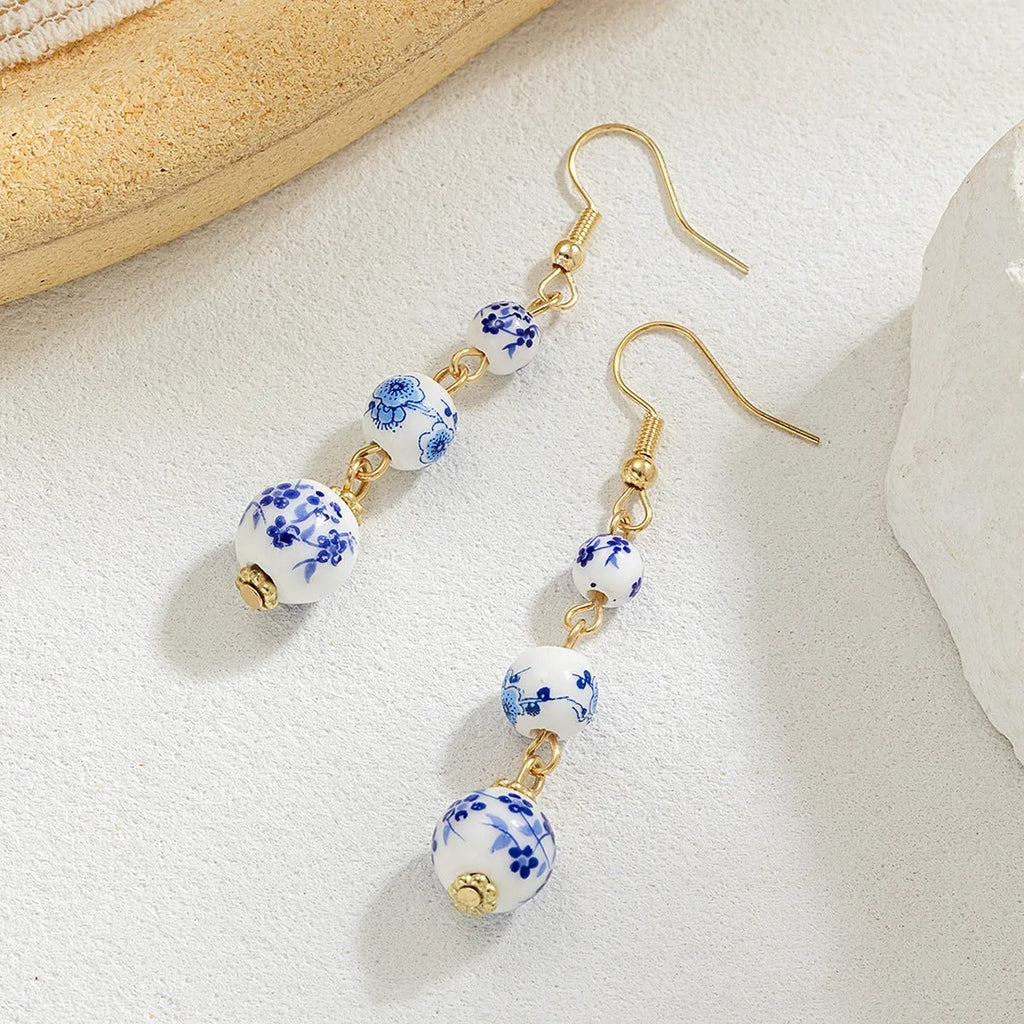 Blue and white porcelain ceramic bead long drop earrings with geometric alloy design
