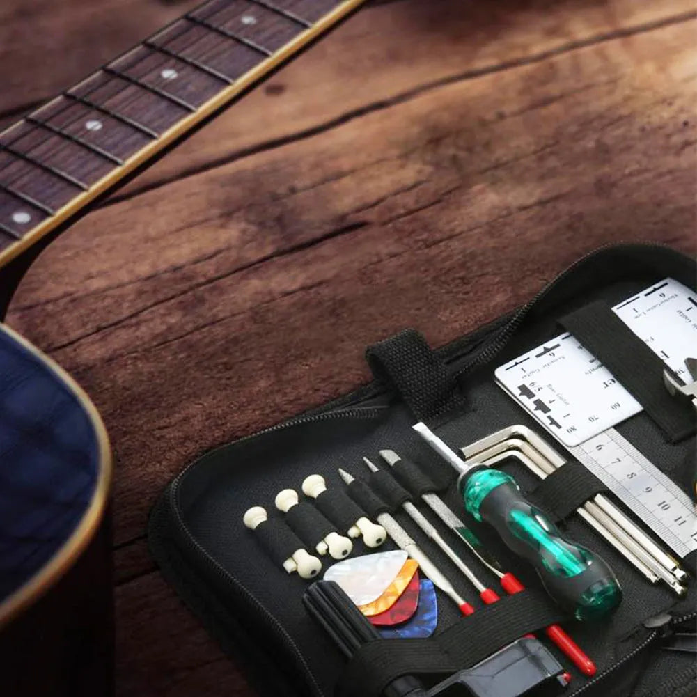 Black plastic toolbox containing a guitar repair and maintenance tool kit for guitar, bass, mandolin, and banjo.