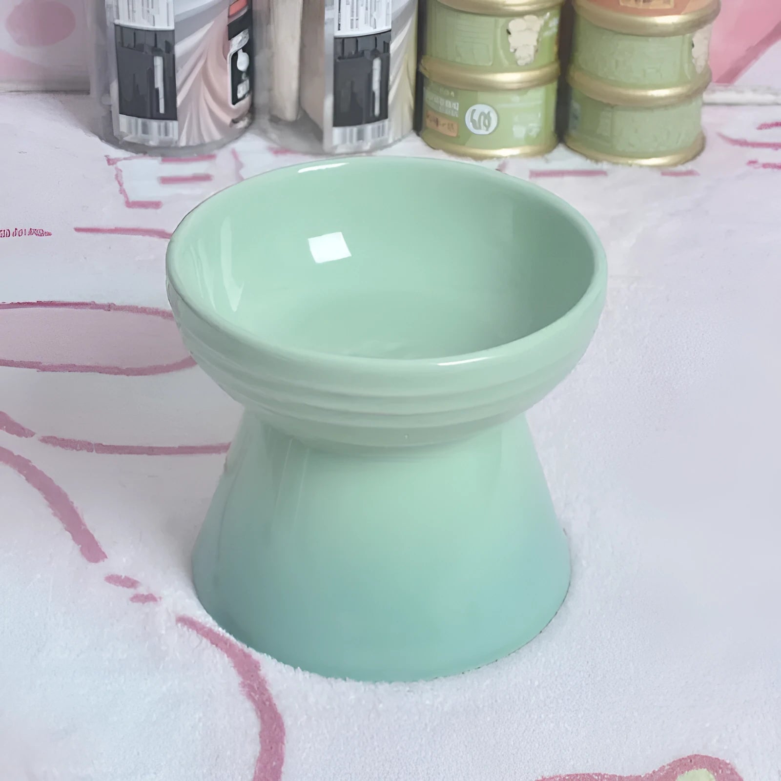 Black chin-high foot ceramic pet bowl for dogs and cats on a flat surface.