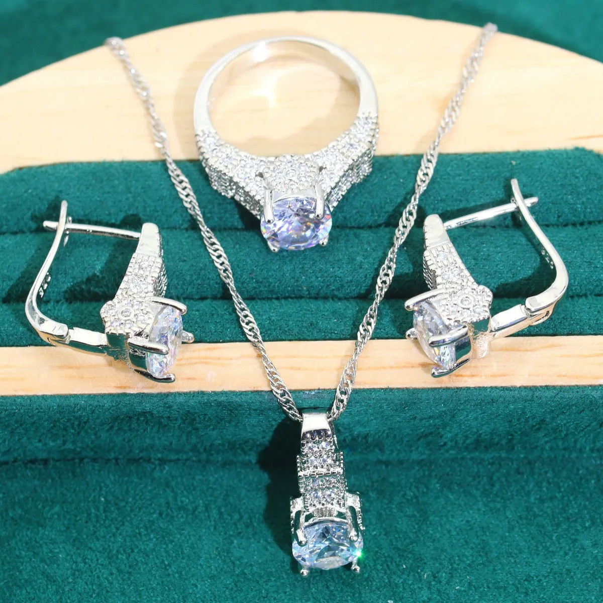 Four-piece bridal zircon jewellery set with necklace, earrings, bracelet and ring in water wave chain design