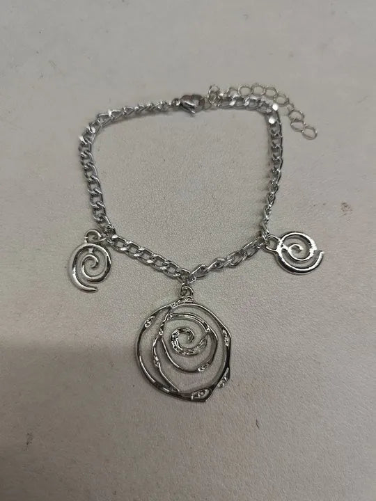 Spiral donut jewellery set showing necklace, bracelet and ear hooks in gold or silver geometric circle design