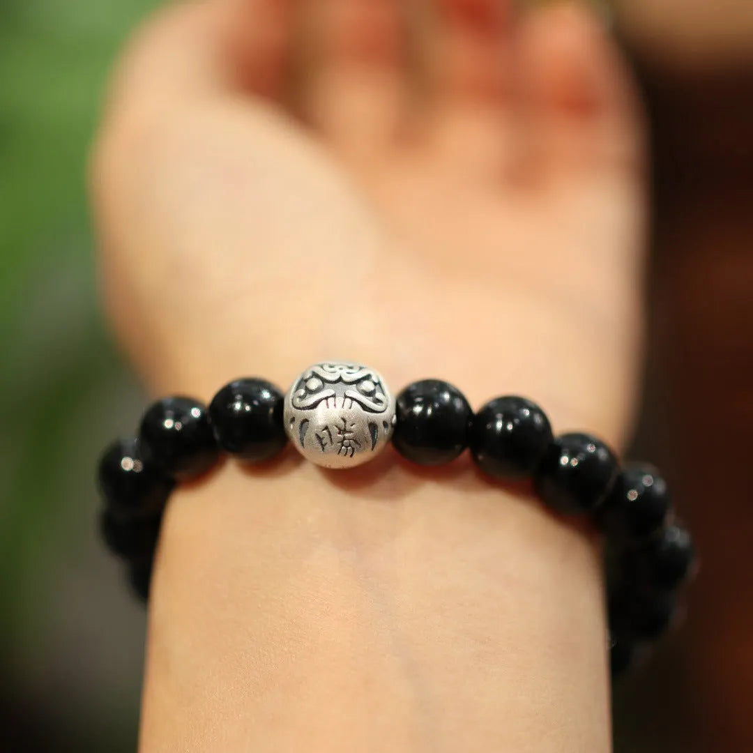 Natural black agate beaded bracelet with sterling silver clasp showing Chinese style threading