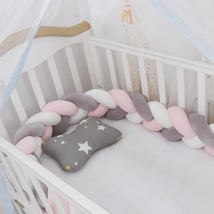 Multi-colour baby crib bumper made of spandex velvet, shown bent around a crib edge.