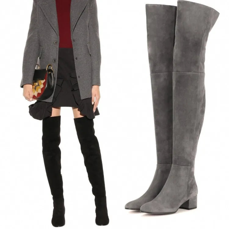 Grey suede women's over the knee flat boots with a pointed toe and thick low heel.