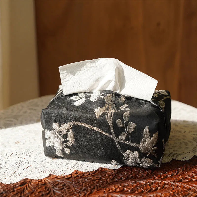 White Chinese brocade fabric tissue box with embroidered plum blossoms, shown with and without a pearl buckle clasp.