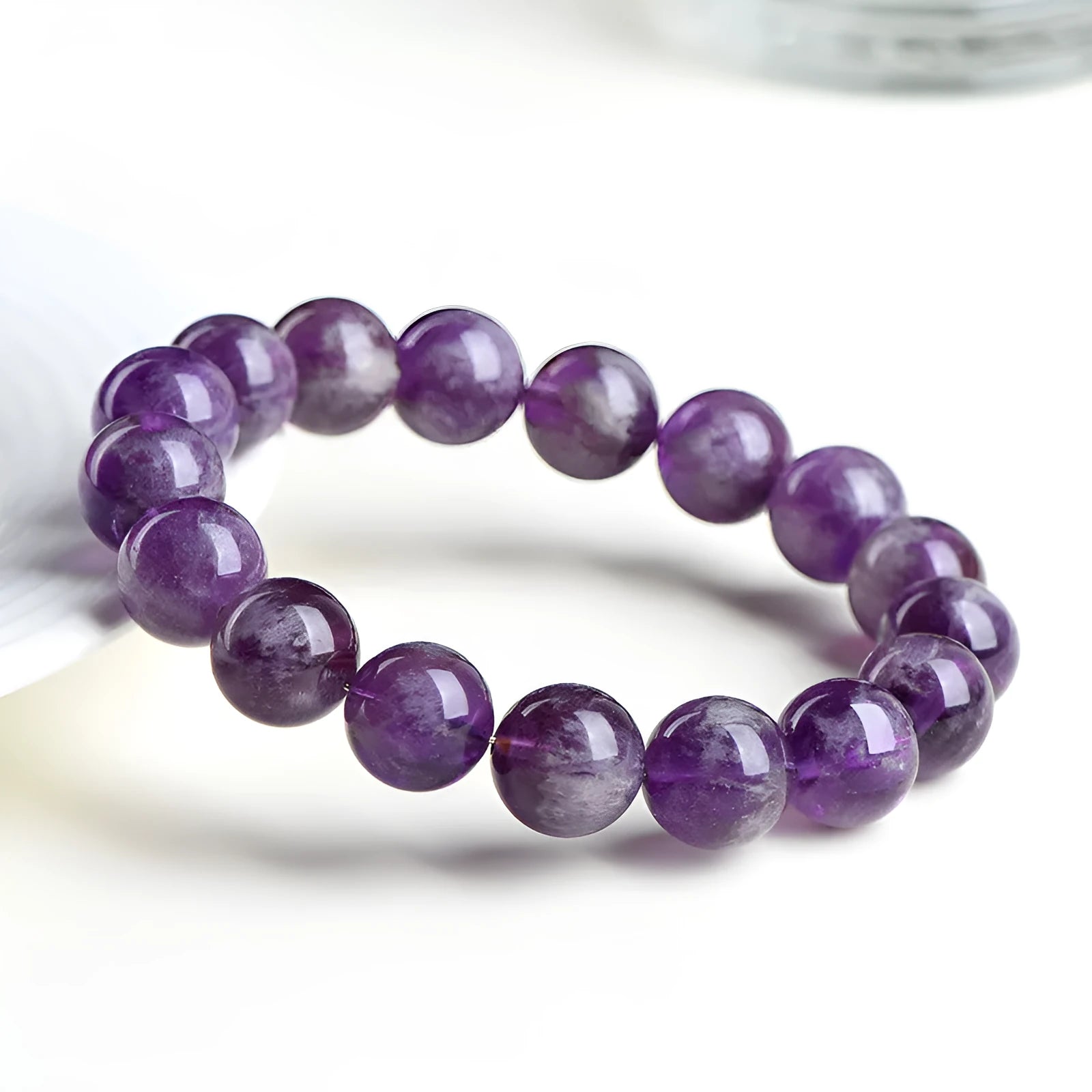 Natural feather amethyst crystal bracelet with scattered beads and a Ruyi symbol in Snow Mountain purple.
