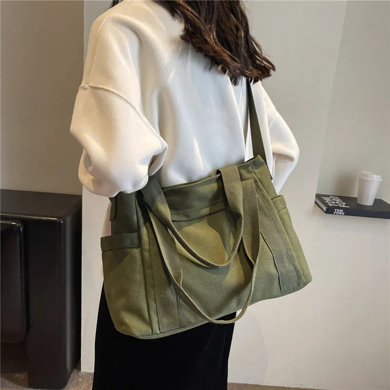 Women's polyester canvas shoulder bag with sandwich pocket in black, white, brown, or green