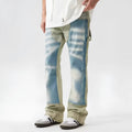 Yellow and blue retro patchwork distressed jeans with splash-ink design details on mid-waist denim trousers