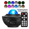 Black parallel finish star projector lamp with rotating water ripple laser effects on desktop