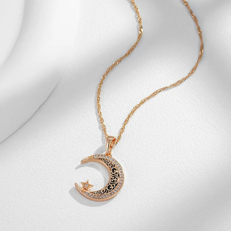 Rose gold star and moon necklace with enamel detailing on adjustable water wave chain