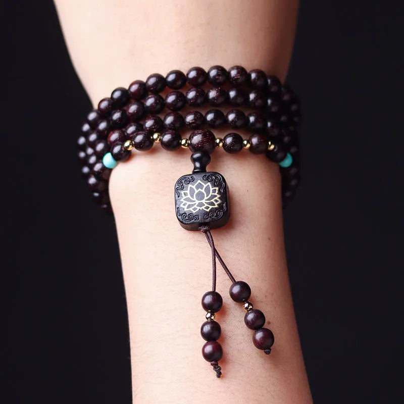 Zambia rosewood DIY bead bracelet with flat lotus pendant ornament on wooden surface