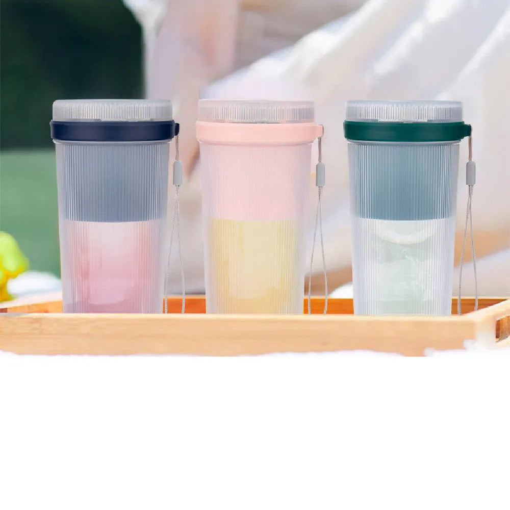 Portable electric blender cup in blue, green, or pink with USB charging cable.