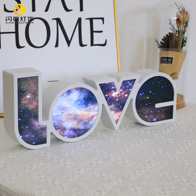 LED decorative light with rainbow-coloured LOVE word on plastic shade