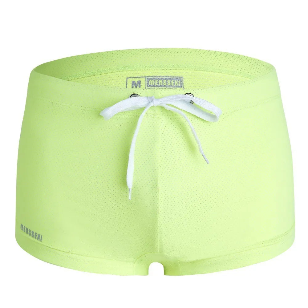 Men's low waist nylon swimming trunks in a solid colour on a white background.