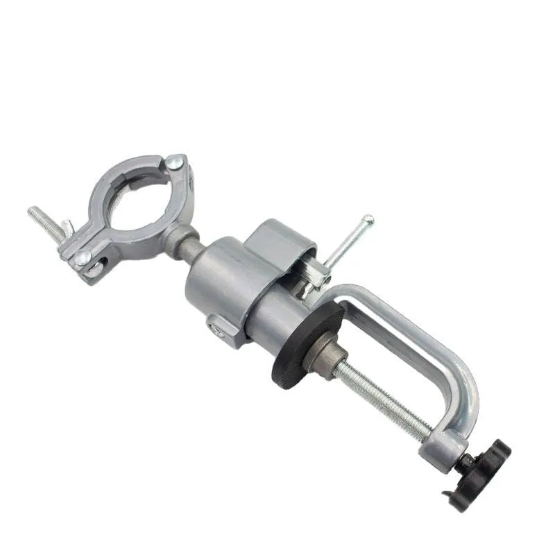 Small flat bracket-type clamp-on bench vise with a 360-degree rotating head on a workbench.