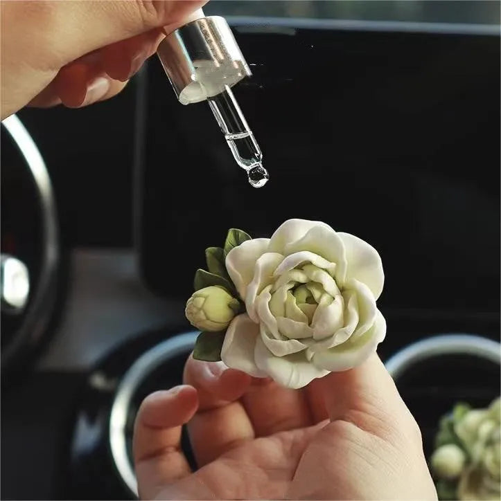 Solid gypsum car air freshener diffuser in air vent with jasmine fragrance oil.