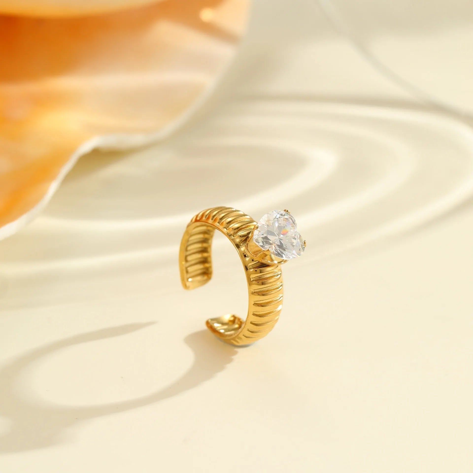 Gold electroplated stainless steel ring with zircon geometric designs and open mouth adjustable fitting