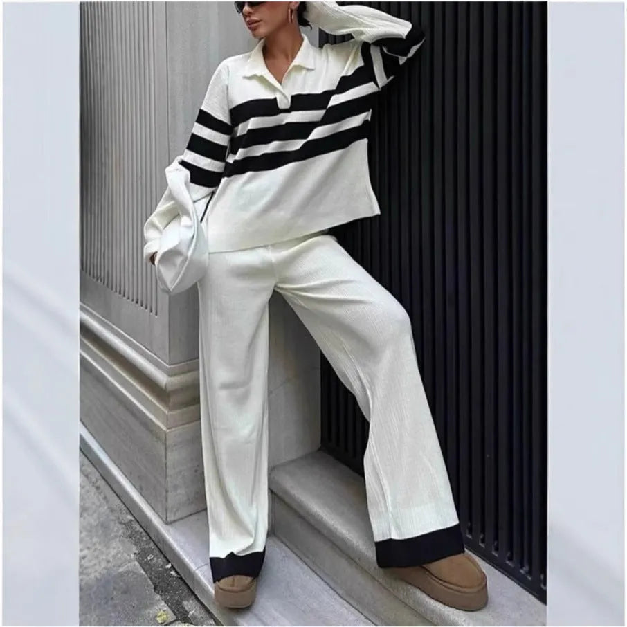 Women's black knitted two-piece set with polo collar top and straight-leg trousers.