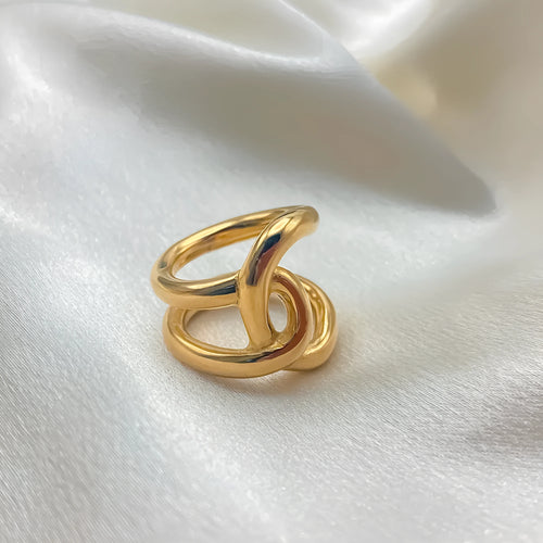 Adjustable geometric ring with knotted design in stainless steel showing U-shaped form and opening mechanism