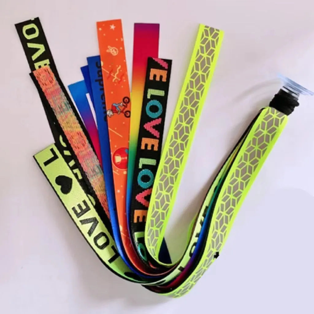 Colourful fabric helmet streamers for children's roller skating and ski helmets, shown in apricot, red, and grey.