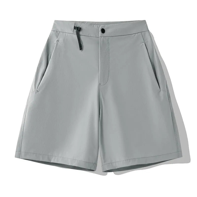 Men's solid colour quick-dry sports shorts with elastic sides on a neutral background.