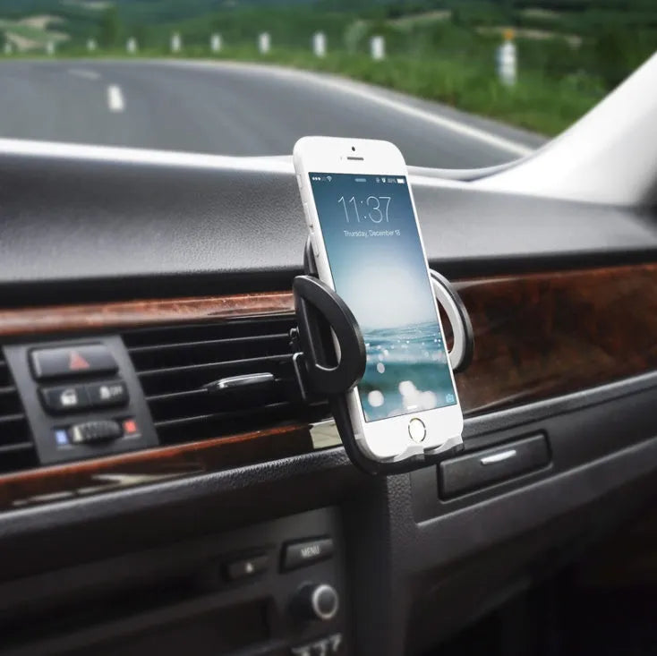 Black universal car air vent mobile phone holder mounted on a car vent, holding a smartphone.