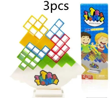 Plastic balance stacking board game with 16 coloured building blocks, chassis, and base on table.