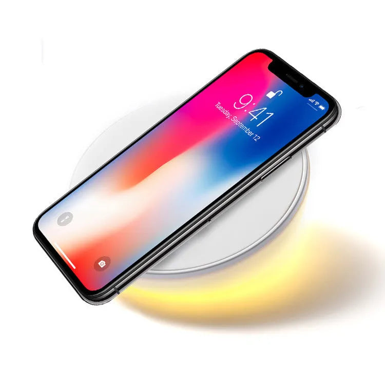 White wireless phone charger with digital clock display and three control buttons on the front.