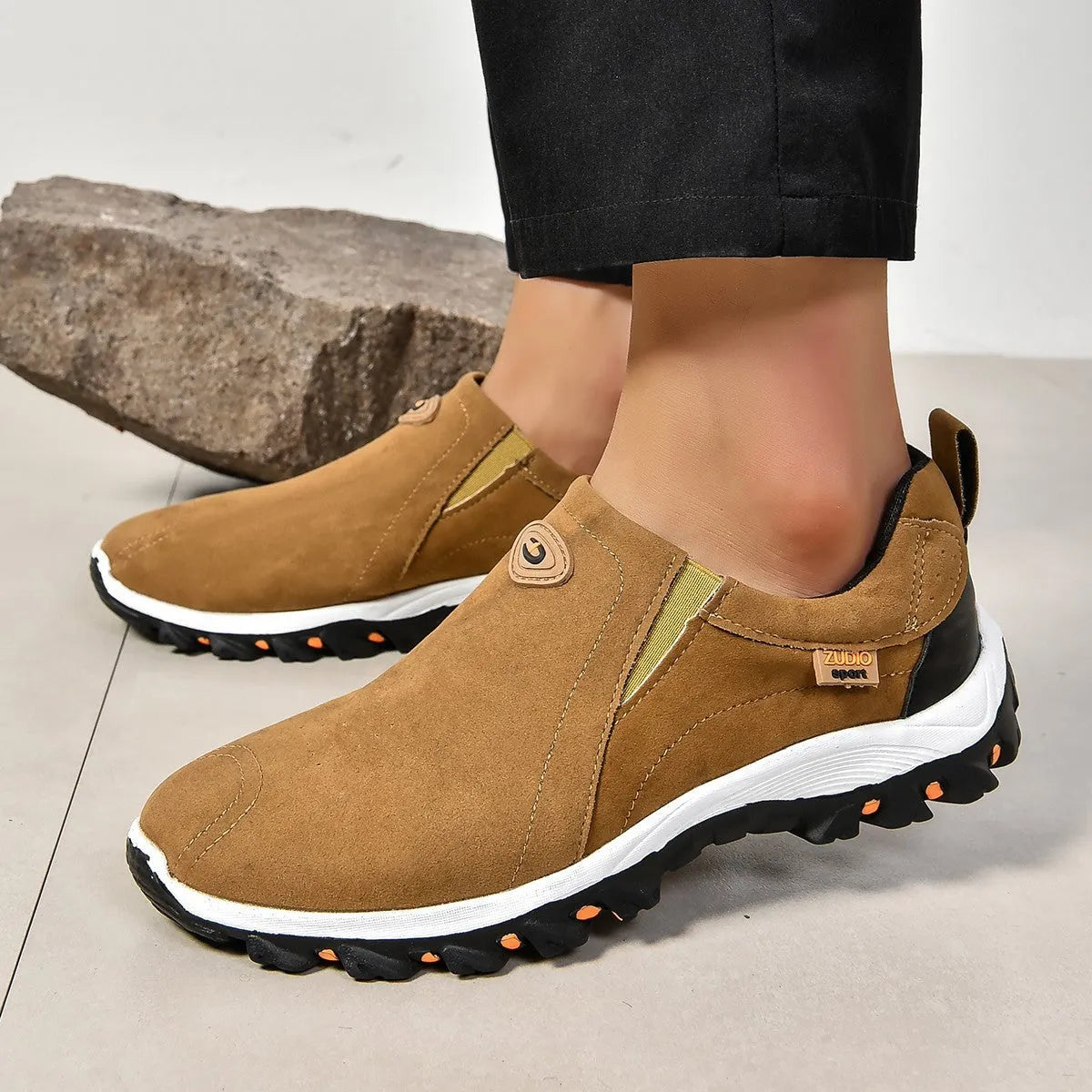 Men's black elastic slip-on shoe covers with round toe and rubber sole, showing PU upper material.