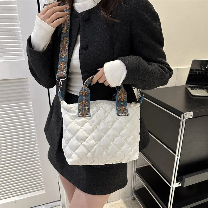 A soft Oxford cloth messenger bag in a horizontal square shape with a single shoulder strap, shown in one of five available colours.
